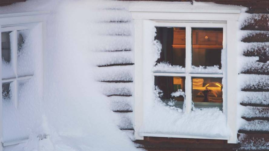 The visitor hut, covered in wind swept snow, at the top of Mount Storsteinen in Tromso, Norway