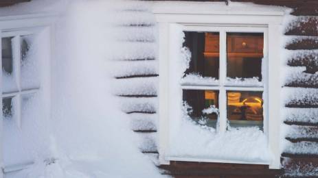 The visitor hut, covered in wind swept snow, at the top of Mount Storsteinen in Tromso, Norway